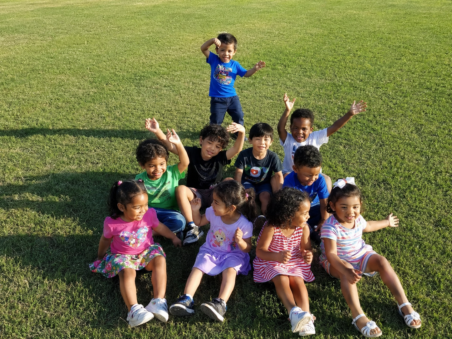 Children together on a grassy lawn